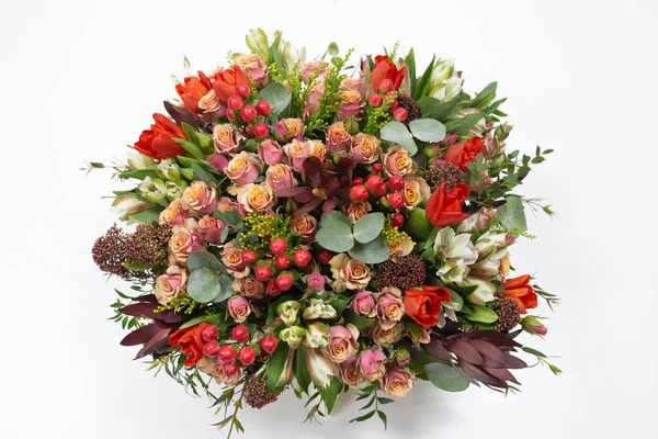 Flower arrangement (bouquet) of fresh flowers (red, pink, beard) in a cardboard box on a white background