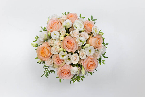 Wonderful flower arrangement in a hat box on a light background (Flowers: Rose, Eustoma. Colors: white, pink, beige)