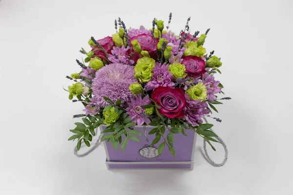 Perfect flower arrangement (Rose, Chrysanthemum, Eustoma, Lavender) in red and lilac colors on a light background