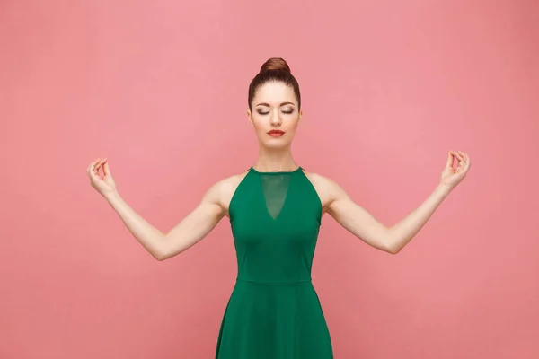 Beautiful Woman Collected Hair Green Dress Keeping Eyes Closed Holding — Stock Photo, Image