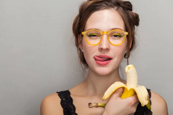 Portrait Seductive Woman Glasses Holding Banana Showing Tongue Out While — Stock Photo, Image