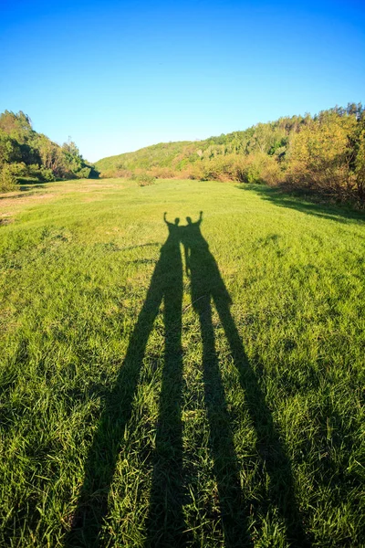 Shadows Two Men Raised Hands Summer Green Meadow Sunny Day — Stock Photo, Image