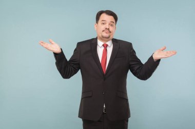 businessman with mustache wearing black suit and red tie spreading his hands to sides on light blue background   clipart