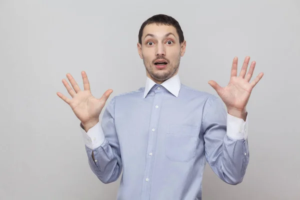 Portrait Shocked Businessman Raised Arms Looking Camera Scared Face Grey — Stock Photo, Image