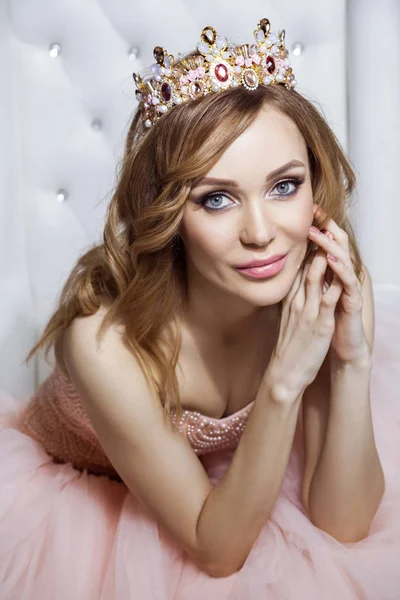 Mooie Vrouw Kroon Luxe Roze Jurk Zittend Een Stijlvolle Witte — Stockfoto