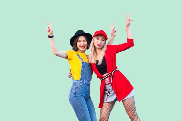 Two Beautiful Happy Fashionable Hipster Women Standing Showing Sings While — Stock Photo, Image