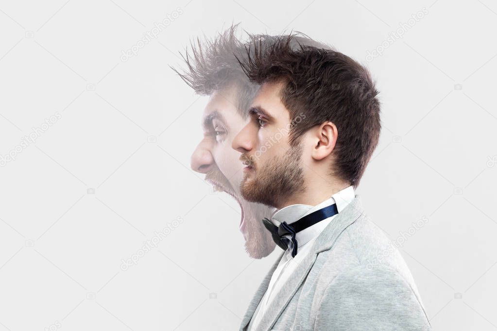 profile portrait of two-faced young man in calm serious and angry screaming expressions on grey background. concept of different emotion inside and outside mood of people 