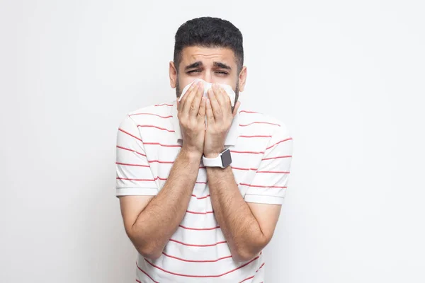 Malato Barbuto Giovane Uomo Strisce Shirt Tenendo Tessuto Sulla Bocca — Foto Stock