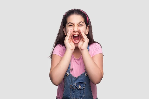 Screaming Brunette Young Girl Casual Pink Shirt Blue Denim Overalls — Stock Photo, Image