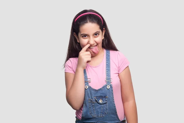 Funny Brunette Young Girl Pink Shirt Blue Overalls Showing Tongue — Stock Photo, Image