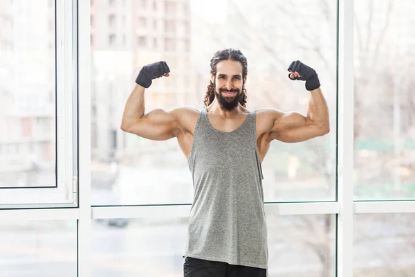 Satisfied Sporty Young Adult Muscular Trainer Man Curly Long Hair — Stock Photo, Image