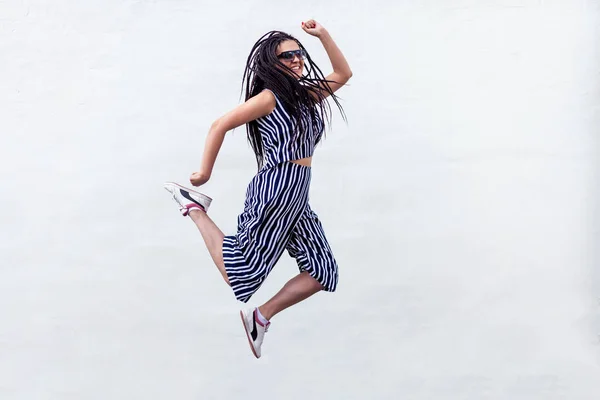 Happy Young Brunette Woman Dreadlocks Hairstyle Striped Clothes Sunglasses Jumping — Stock Photo, Image