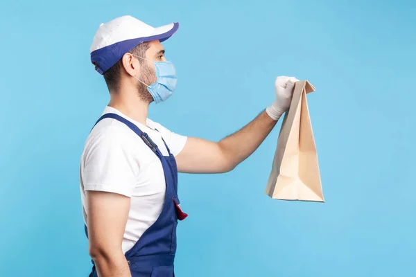 Seitenansicht Freundlicher Professioneller Kurier Uniform Maske Und Schutzhandschuhe Der Lebensmittel — Stockfoto