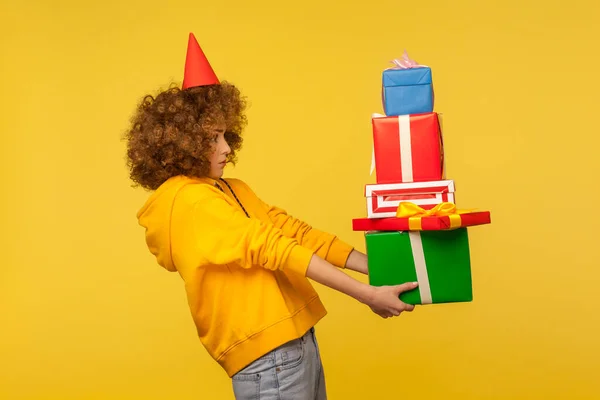 Portrait Generous Curly Haired Woman Party Cone Giving Many Present — 스톡 사진