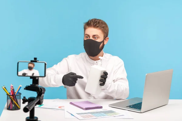 Masked Gloved Man Pointing Bottle Antibacterial Gel Showing Antiseptic Webcam — Stock Photo, Image