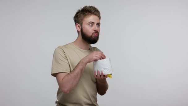 Bärtiger Mann Der Chips Aus Der Packung Isst Und Begeistert — Stockvideo