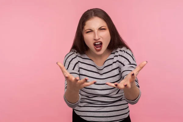 What do you want? Portrait of furious irritated woman in striped sweatshirt raising hands, looking angrily with indignant expression, quarrel and complete misunderstanding. indoor studio shot isolated