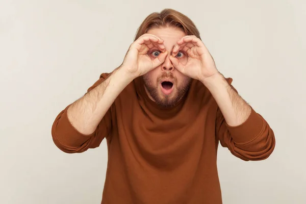 Portrait Funny Curious Man Looking Binoculars Finger Gesture Spying His — Stock Photo, Image