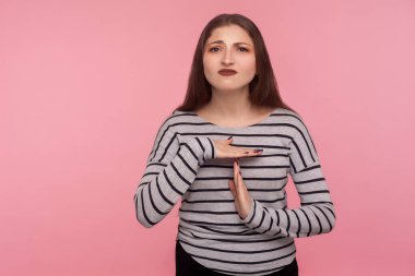 Dur, biraz ara ver! Çizgili tişörtlü, yorgun, mutsuz bir kadının portresi. Mola verme hareketi, sınır uyarısı, son teslim tarihinden önce duraklama. Pembe arka planda kapalı stüdyo çekimleri