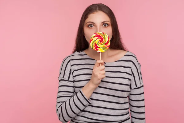 Portrait Amazed Woman Striped Sweatshirt Licking Lollipop Tasting Sweet Rainbow — Stock Photo, Image