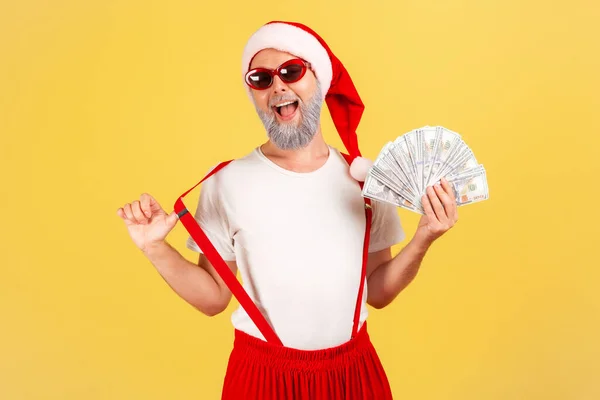 Excited Positive Elderly Man Santa Claus Hat Sunglasses Showing Fan — Stock Photo, Image