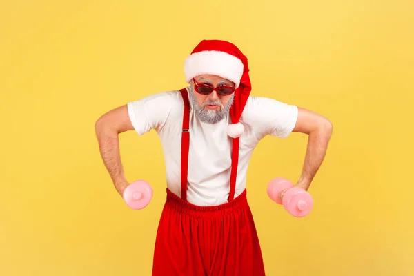 Assertive Elderly Man Stylish Eyeglasses Santa Claus Costume Pumping Muscles — Stock Photo, Image