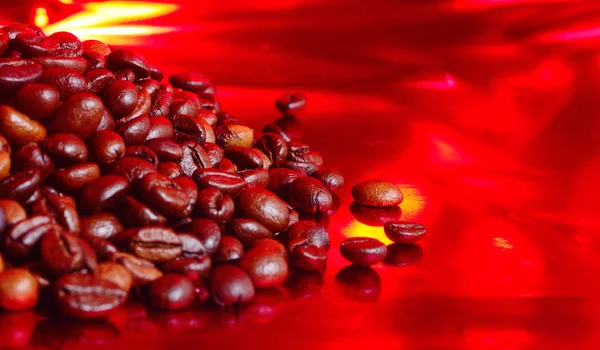 Coffee beans on red background.