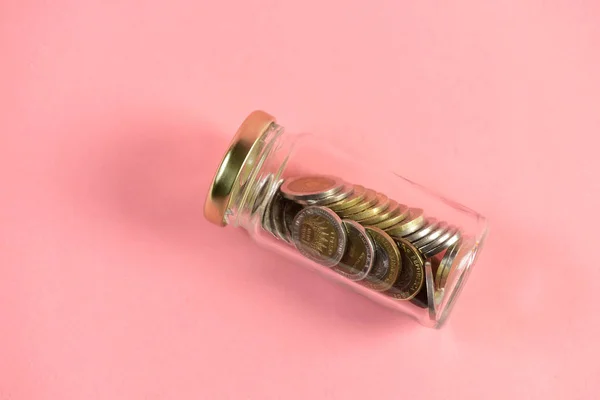 coins in jar, saving concept