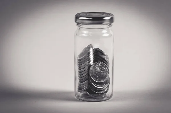 coins in jar, saving concept