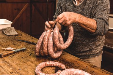 male hands preparing sausages