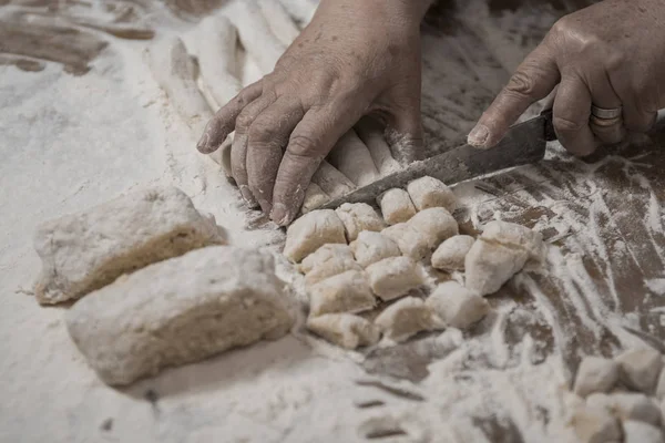Female hands cooking handmade gnocchi