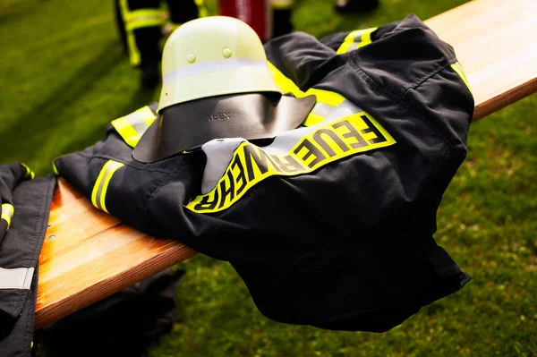 Germany, Niederstetten, Baden Wurttemberg. September 2019. Firefighters uniform with text Feuerwehr, in inglish fireman. — Stock Photo, Image