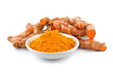 Zerdeçal tozu beyaz üzerinde zerdeçal kökü