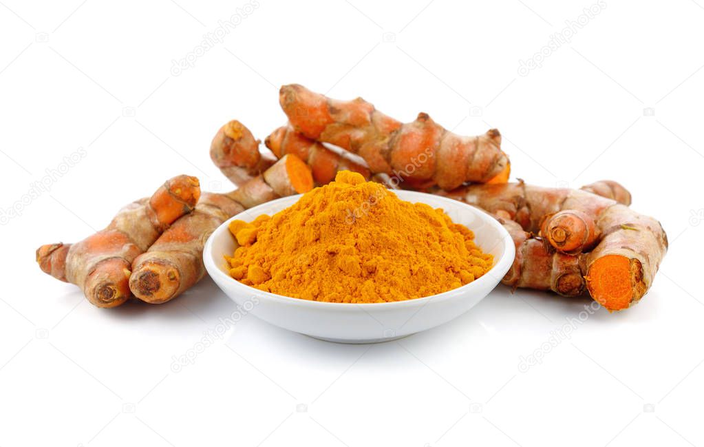 Turmeric roots with turmeric powder isolated on white background