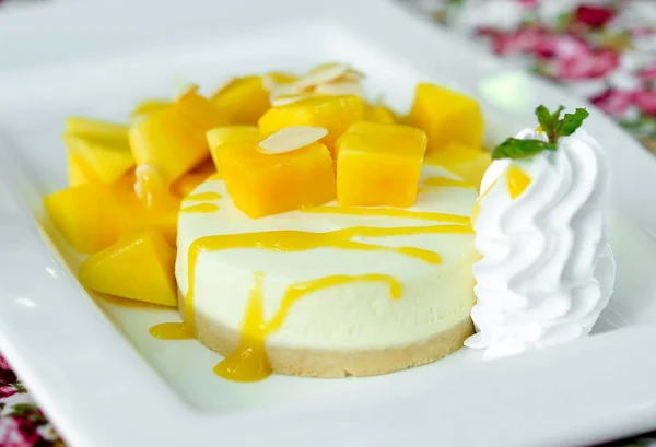 Mango cheesecake on white plate