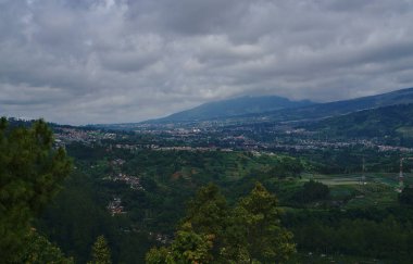Bulutlu gün arka planda küçük dağa ile uzak kenti