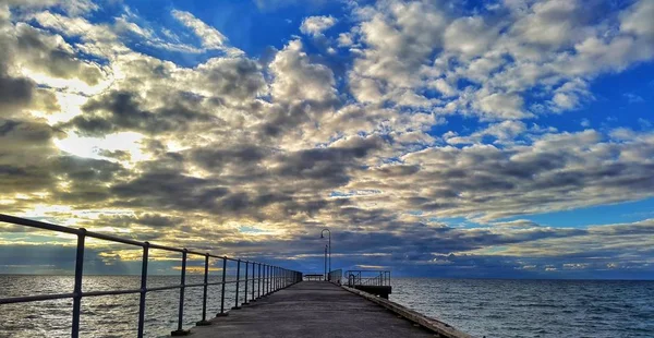 Stock image Dramatic clouds on pier