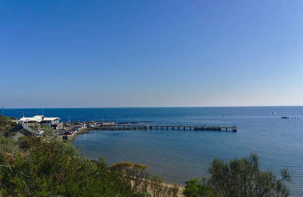 Strand Pier met kalme zee tijdens zonnige dag met blauwe lucht — Stockfoto