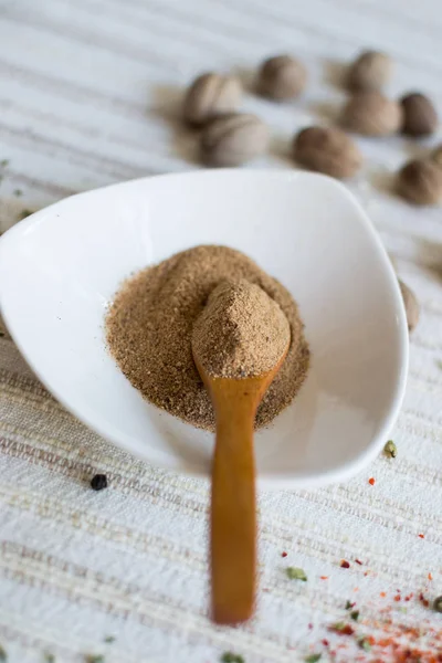 Ground Nutmeg White Bowl Wooden Spoon — Stock Photo, Image