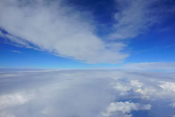 Beautiful blue sky with clouds. corridor between clouds. view from airplane porthole — Stock Photo, Image