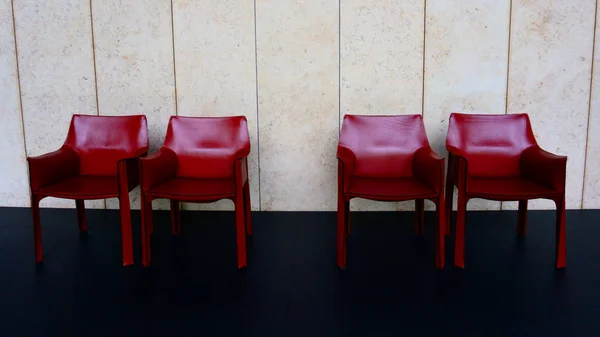 Four Red Chairs Black Floor White Wall Stock Photo