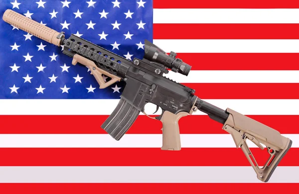 Modern military automatic carbine M4A1 against the background of the American flag. Machine gun on the flag mount.Modern automatic rifle.