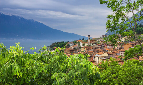 Panoramic view of the city on the shore of lake Garda on an overcast day. Soft focus and blurred background.