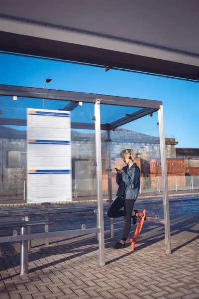 Woman Using Mobile Phone Bus Stop Sunny Day — Stock Photo, Image