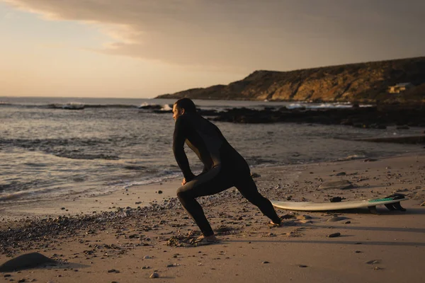 Surfer Stretching Beach Sunset — Stock Photo, Image