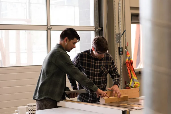 Two Craftsmen Discussing Wooden Plank Workshop — Stock Photo, Image