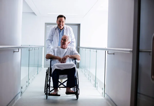 Doctor Interacting Male Senior Patient Wheelchair Passageway — Stock Photo, Image