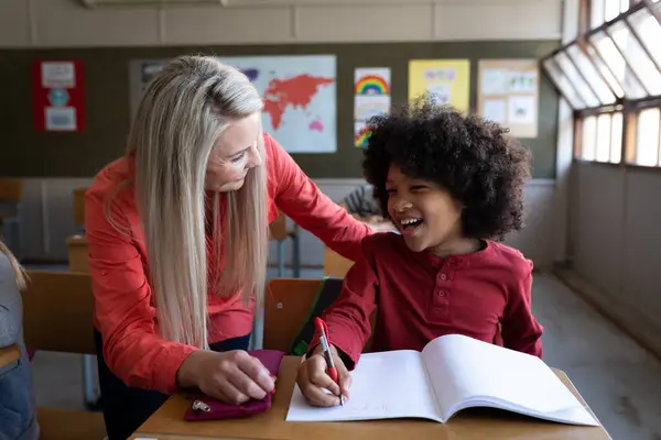 Female Caucasian Teacher Teaching Mixed Race Boy Lesson Primary Education — Stock Photo, Image