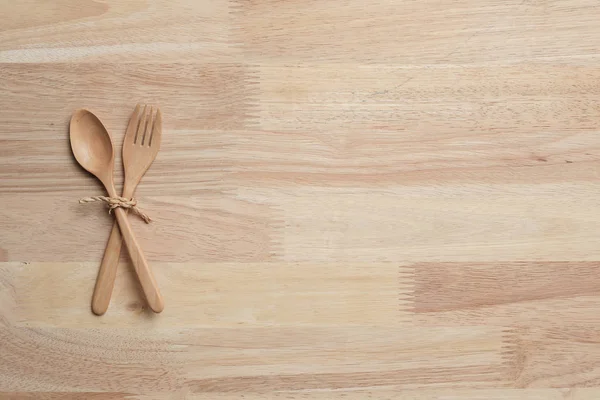 wooden table top with Kitchen ware for the background