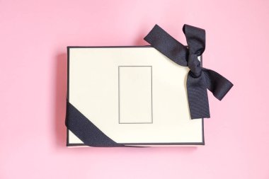 Noel, Yeni Yıl, Anneler Günü, yıldönümü, doğum günü, parti, pembe bir arka plan, üst görünüm üzerinde izole için bir hediye olarak renkli kurdele ile Hediye kutusu. İş yerinde bir iş arkadaşına hediye